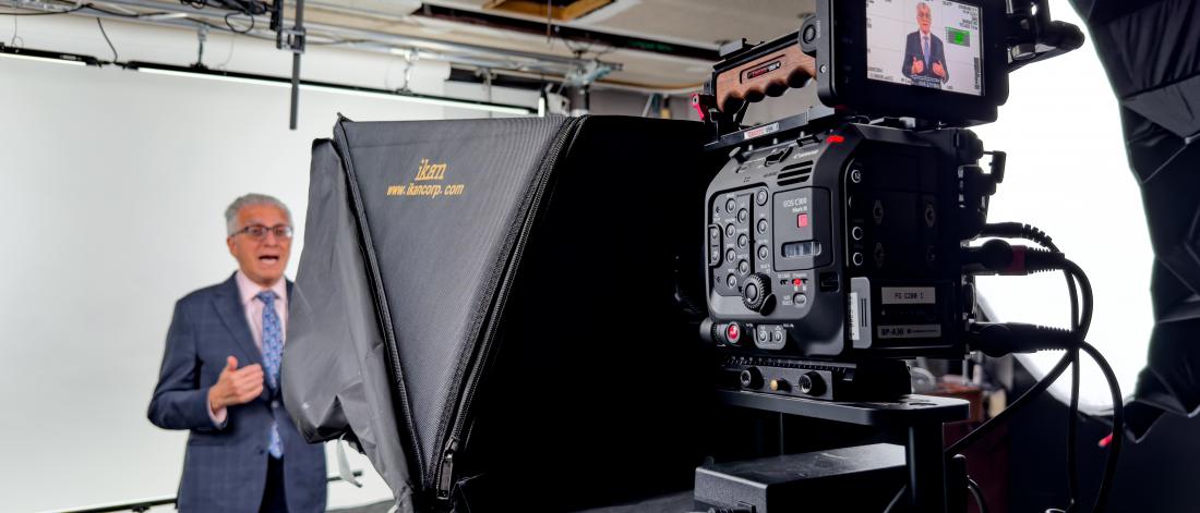UM President Michael Benarroch standing in front of a video camera