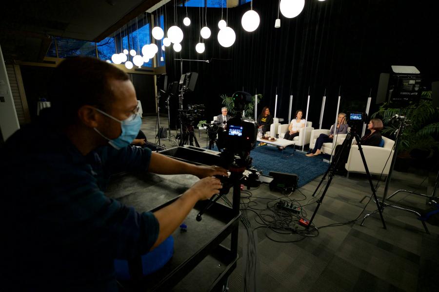 Man works camera at special event.