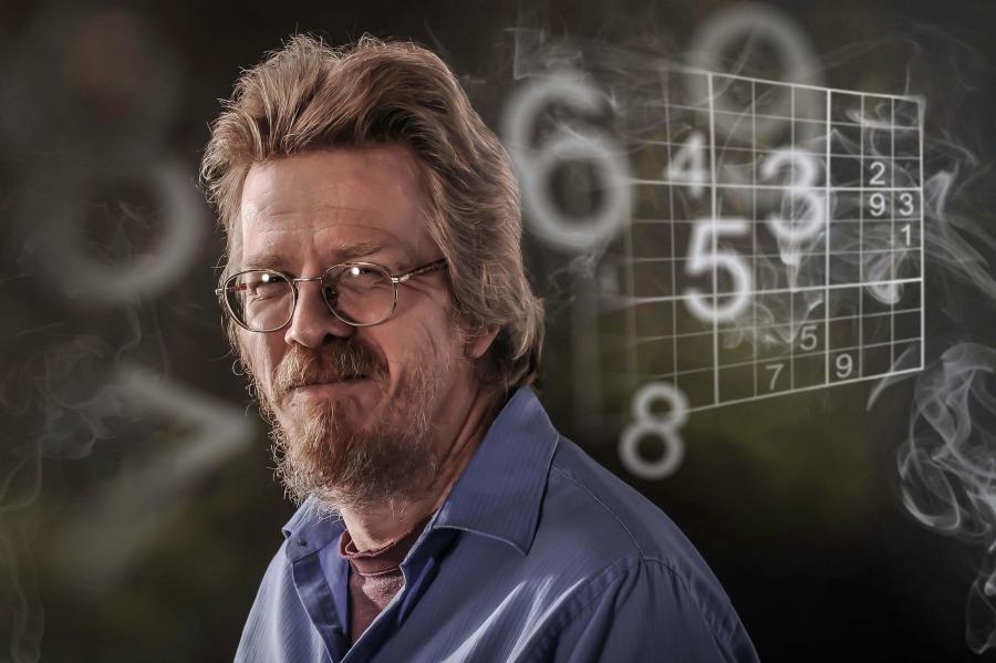 Man with smoke and numbers background.