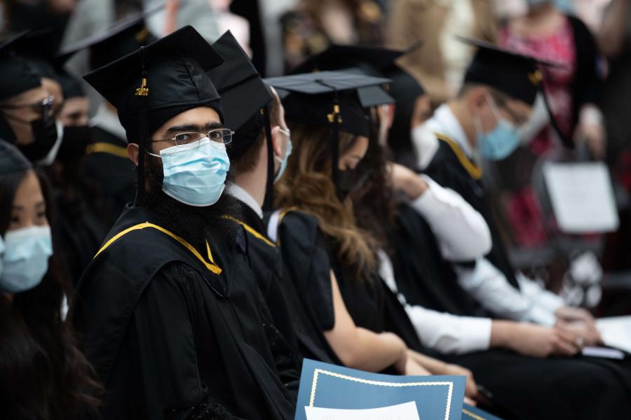 Graduation ceremony participant wearing medical mask.