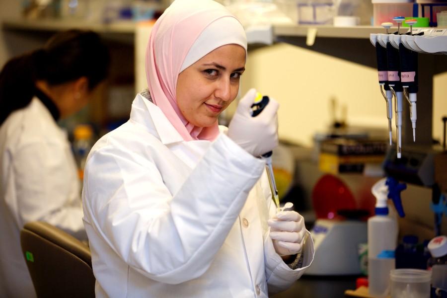 Scientist using a pipette in the lab.