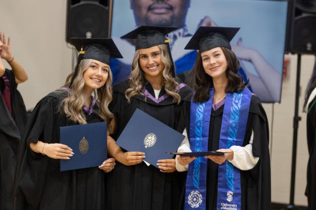 Photo of three graduates