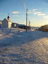Looking down the beach road in Pond Inlet (Roman Catholic Church on left)