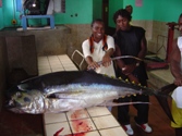 Sandra Grant and fisher with a yellowfin tuna