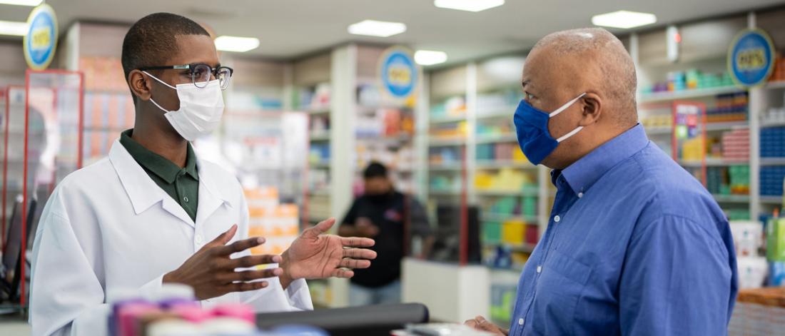 Pharmacist advising a patient.