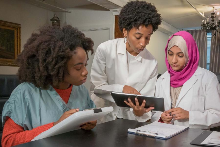 A group of women discussing a document at a table.