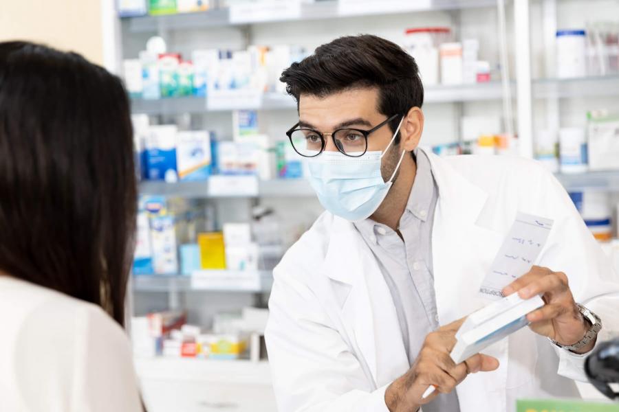 Pharmacist advising a patient.