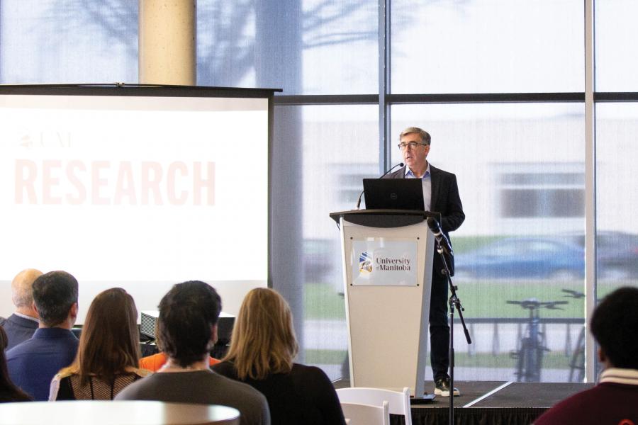 Man at lectern on Research Day 2023