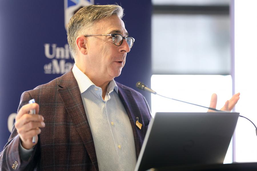 Dean Douglas Brown speaking at a podium during Research Day 2026.