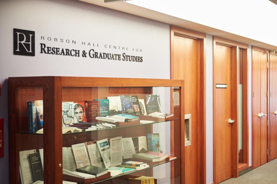 Third floor bookcase featuring faculty publications