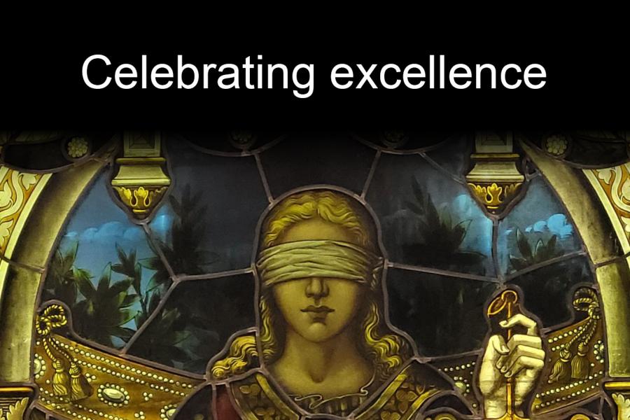 An image of Justice, a stained glass work by Bell McCausland and Robert Robert on display in Robson Hall, with text overlay which reads "Celebrating Excellence"