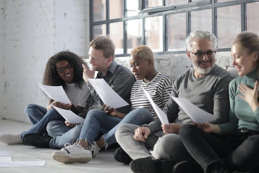 Older people sitting together reading papers