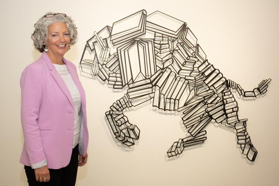 University Librarian Lisa O'Hara with Indenous art installed in Elizabeth Dafoe Library.