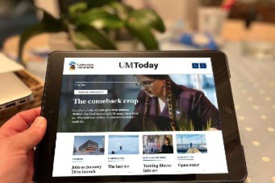 A tablet showing the UM Today homepage with images and articles.