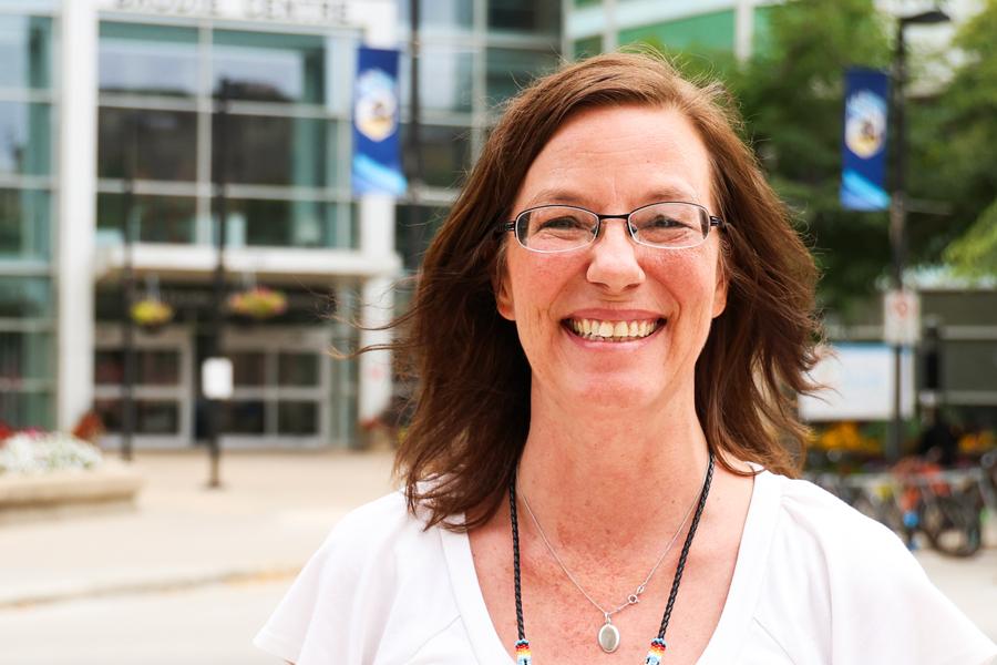 Dr. Tammy Taillieu standing outside, with the Univesity of Manitoba Bannatyne Campus in the background