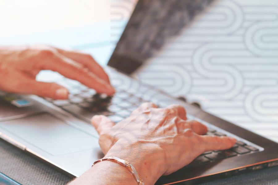 senior typing on keyboard. Photo courtesy Pixabay