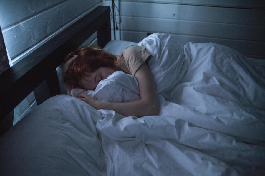 Image of a person sleeping on a bed
