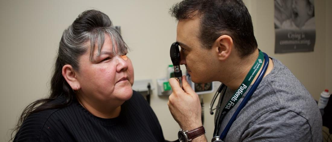 Physician examines a patient's eye.