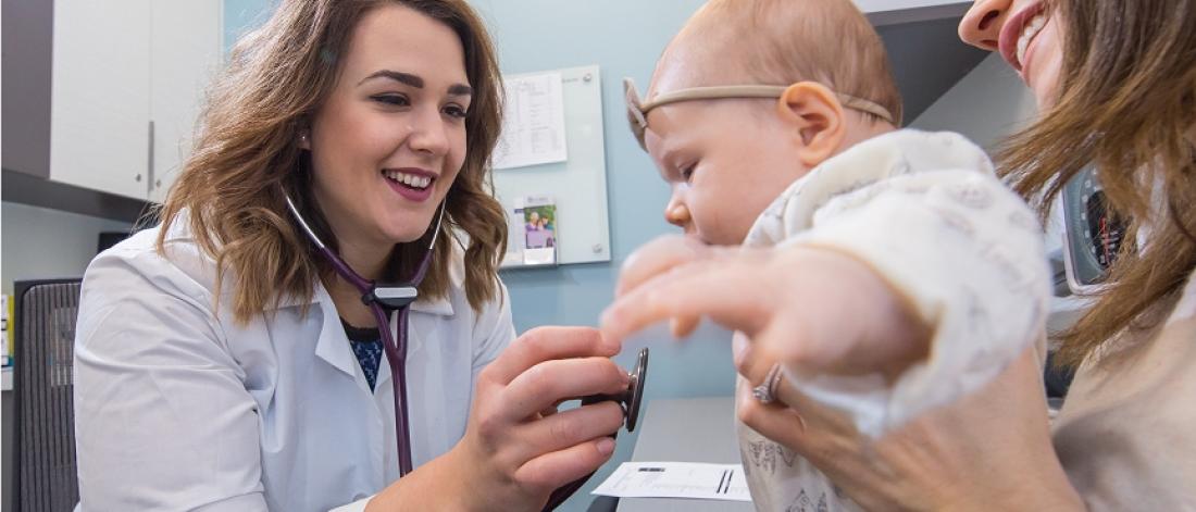 Physician examines a baby