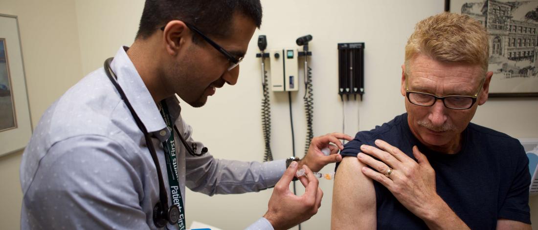 Physician gives patient a vaccine