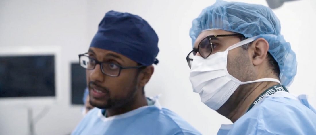 Two doctors in medical scrubs.