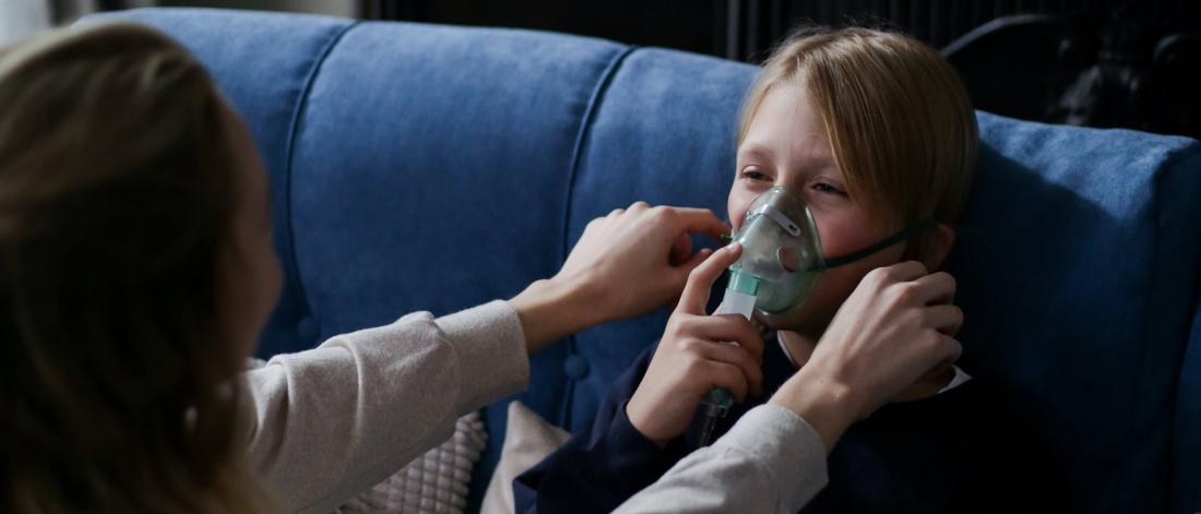 Child using a breathing apparatus.