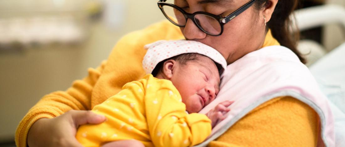 Mother holding a preemie baby.