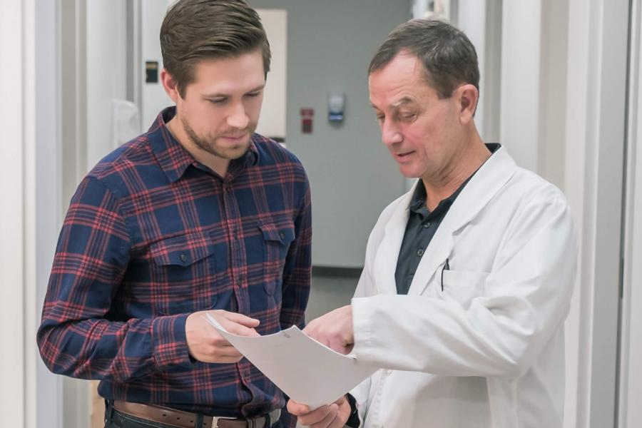 Two physicians review a patient file