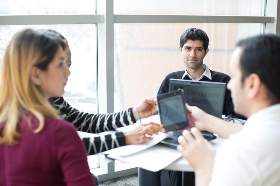 Medical students studying together at a round table.