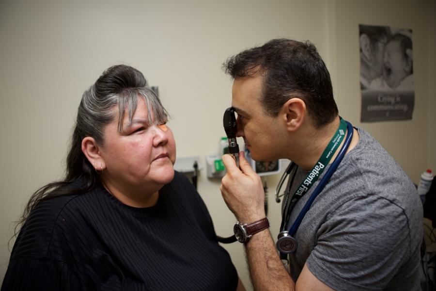 Physician examines a patient's eye.