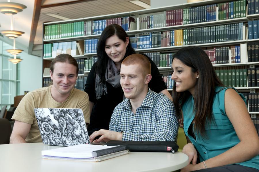 Students working at a laptop.