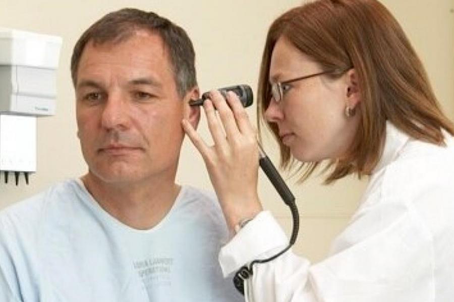 Physician examines a patient's ear.