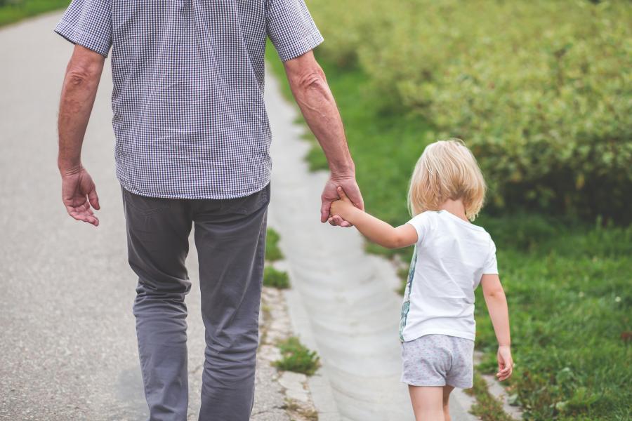 Father holding his little girl's hand.