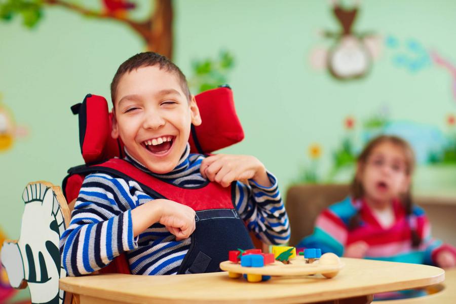 Smiling boy in a wheelchair.