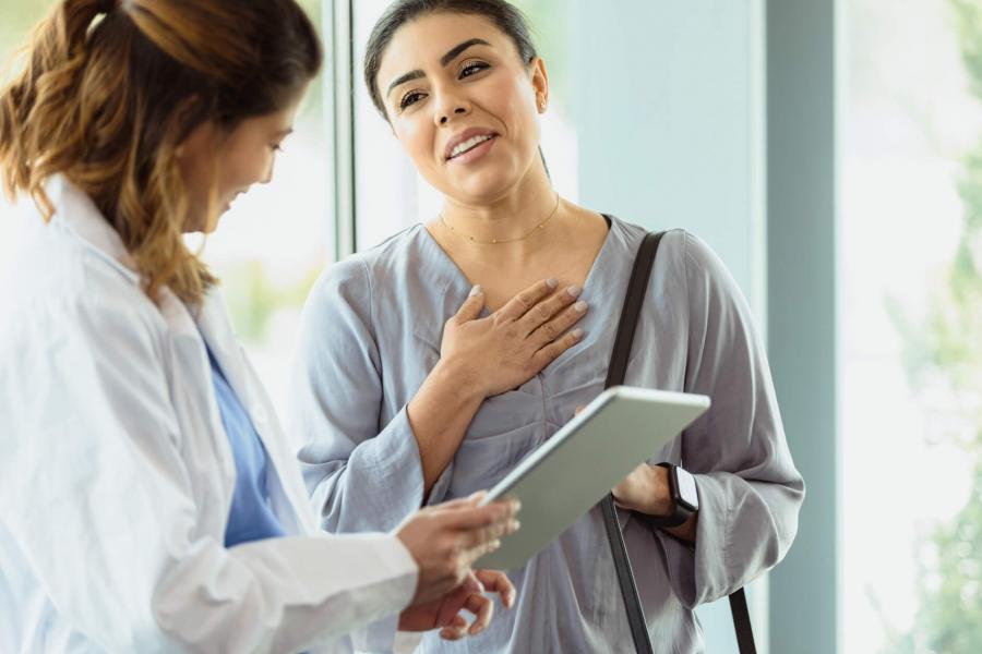 Doctor standing with a patient who looks relieved.