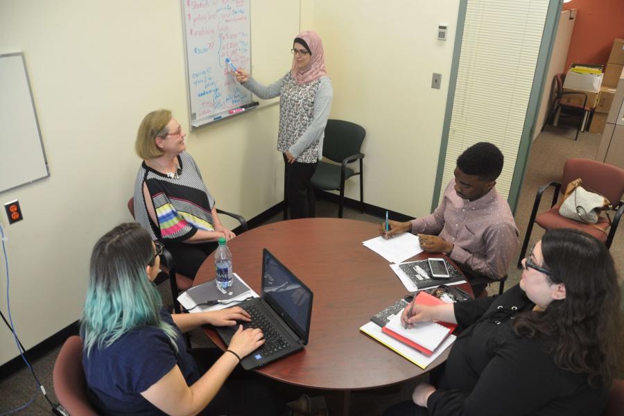 A seminar room with participants looking at a white board.