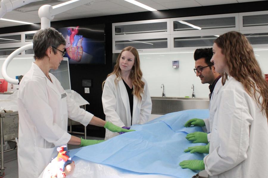 Classroom with an instructor and a draped body.