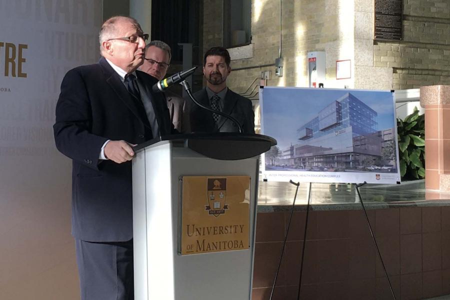 Dr. Brian Postl at a podium, announcing a proposal to establish a physician assistant program
