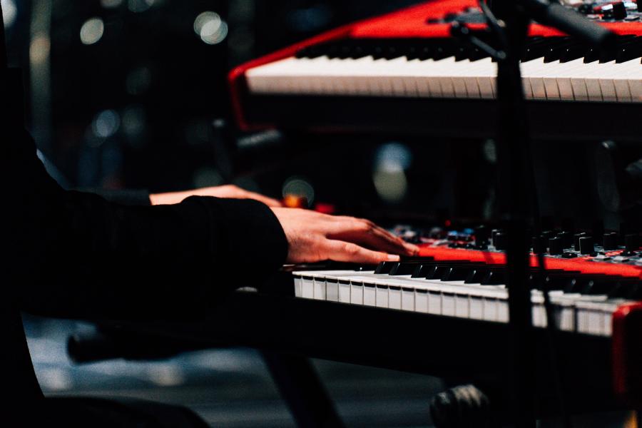 hands playing piano in the concert hall