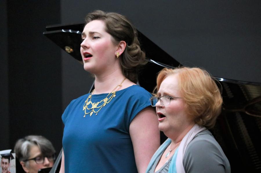 Desautels faculty members Elizabeth Hoyt-Surdhar and Tracy Dahl sing during a Faculty Midday Series titled Mysterious Barricades. 