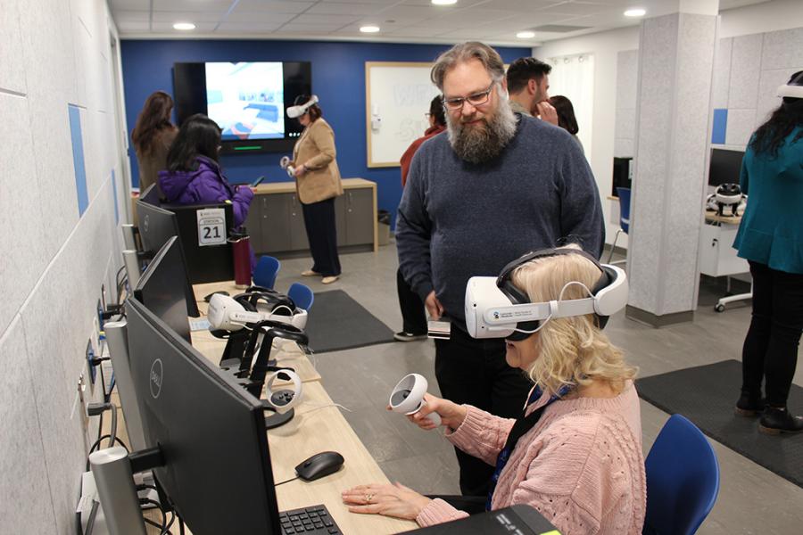 Guests trying out the new virtual reality equipment at the new VR lab grand opening event.