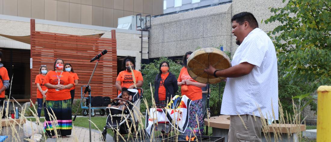 Drummer welcomes group to the medicine garden.