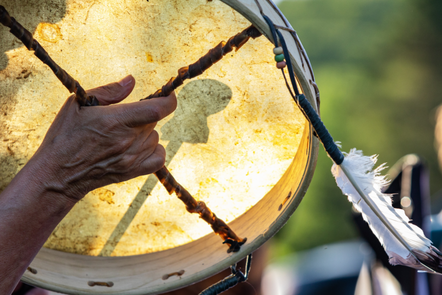 A close up of a hand holding a drum.