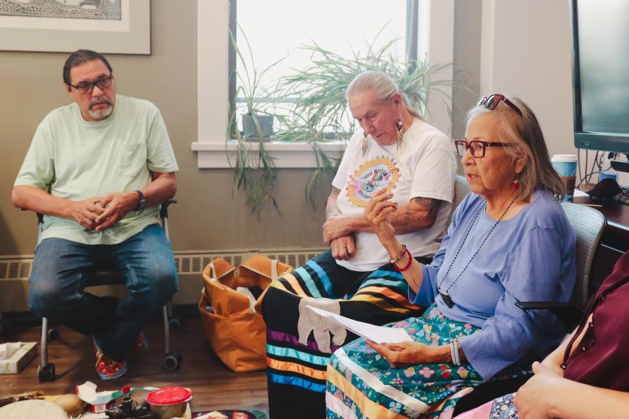 Three members of Ongomiizwin in an office space.
