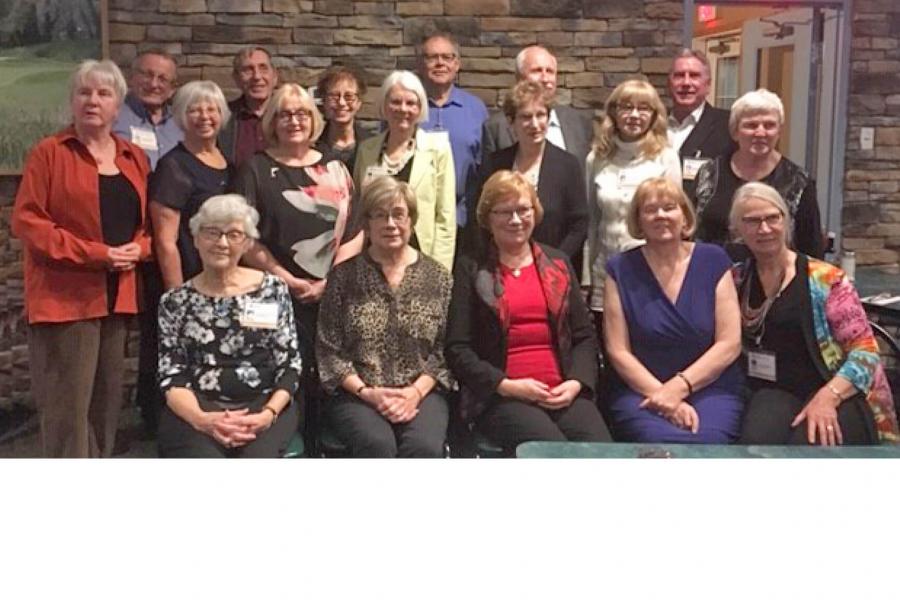 The College of Pharmacy class of 1969 graduates stand together for a group photo during a reunion. 