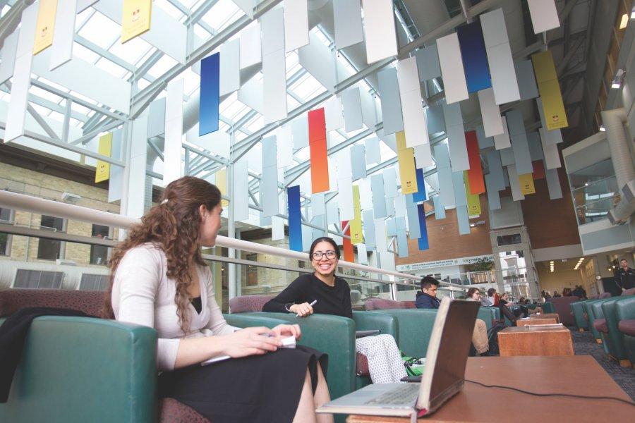 Students relaxing inside the Brodie Atrium.