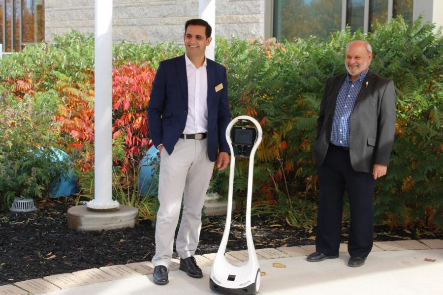 Dr. Amine Choukou and Dr. Reg Urbanowski with the first of the telepresence robots they are developing to assist dementia patients and their caregivers.
