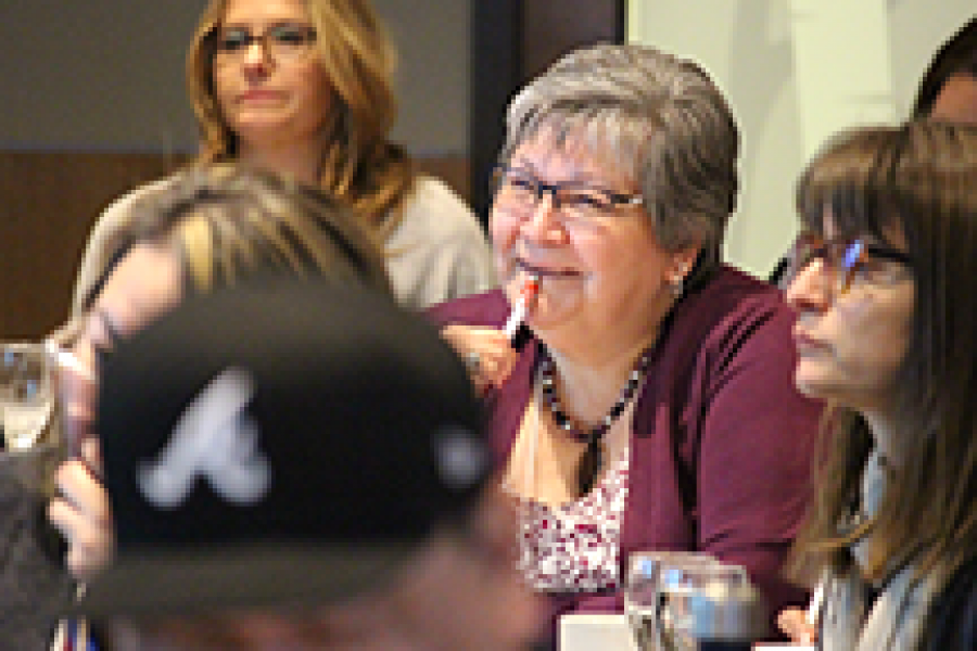 A group of people watching a presenter who is out of the shot.