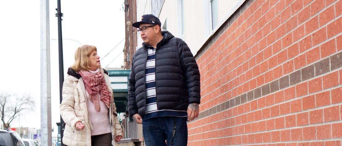 2019 Undergraduate Research award recipient Henry McKay walks down a Winnipeg street with his supervisor.