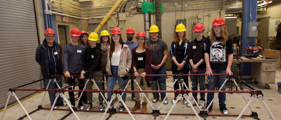 A group of students participating in Science Engineering and Technology day standing together with their instructors.
